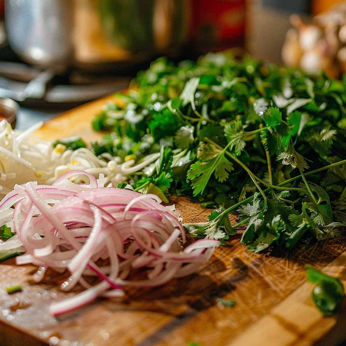 Shallots and cilantro on a cutting board, being chopped for Thai Beef Salad Nam Tok preparation