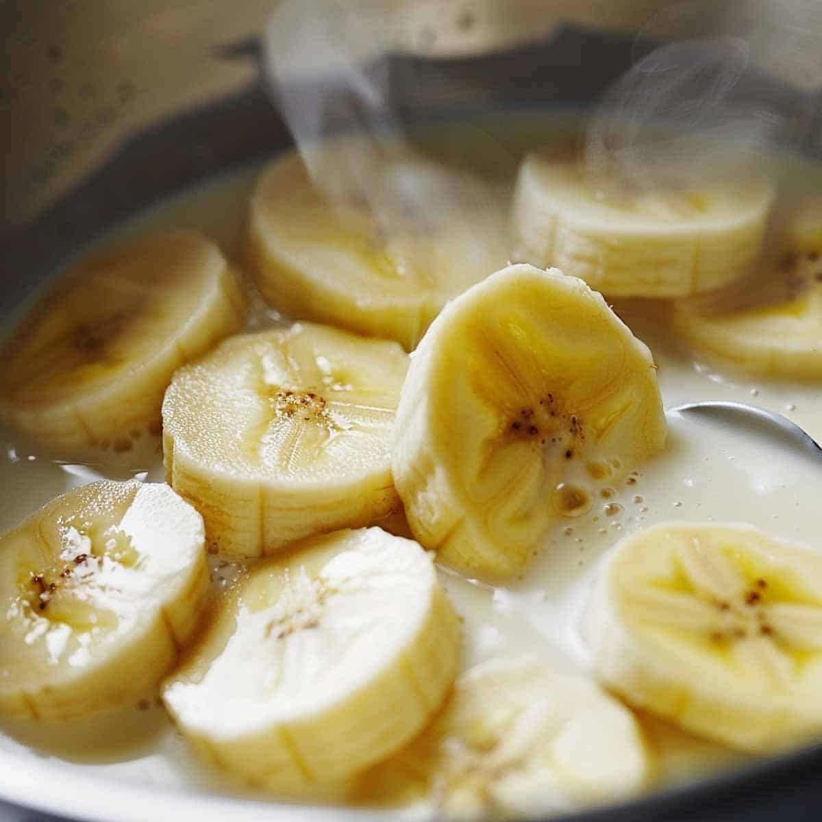 Bananas in Coconut Milk in a saucepan on the stovetop.