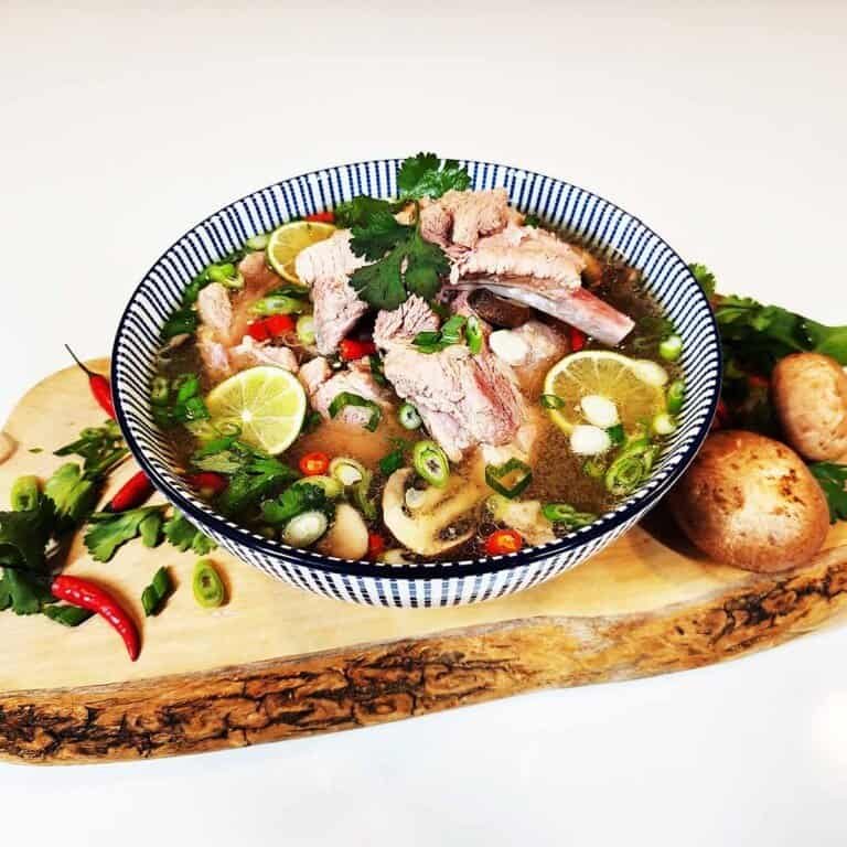 Tom Saap recipe made with tender pork ribs and aromatic Thai herbs in a traditional clay serving bowl