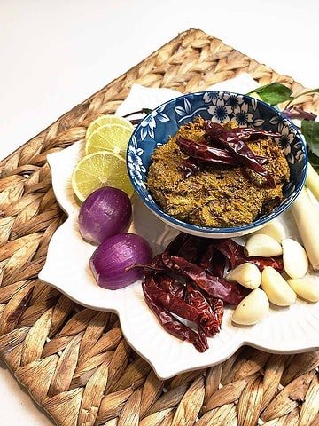 Fragrant Thai yellow curry in a decorative bowl topped with fresh herbs