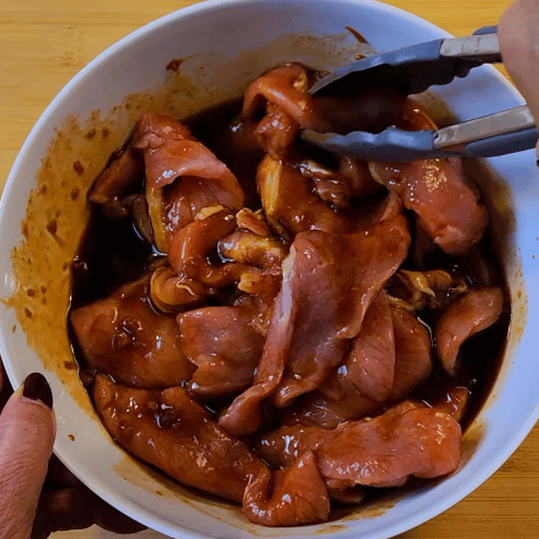 Marinating pork in Thai BBQ sauce