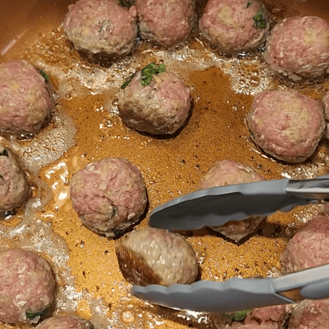 meat balls cooking in pan