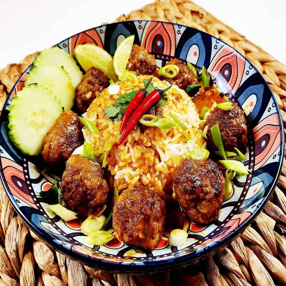 Thai Fusion Red Curry Meat Balls in a bowl with cucumbers and rice