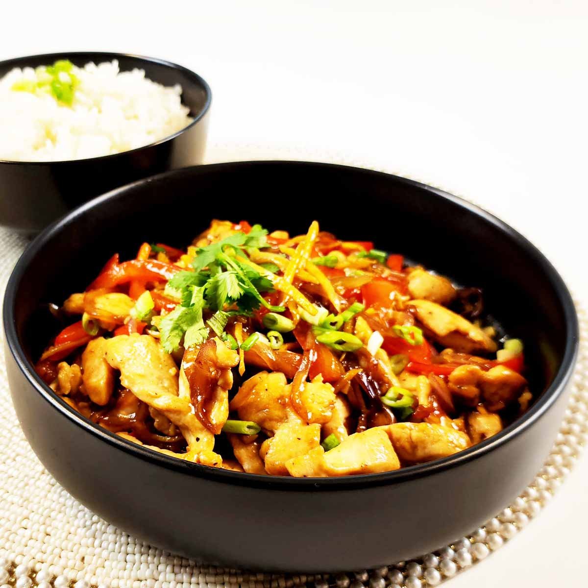 Thai ginger chicken in black bowl