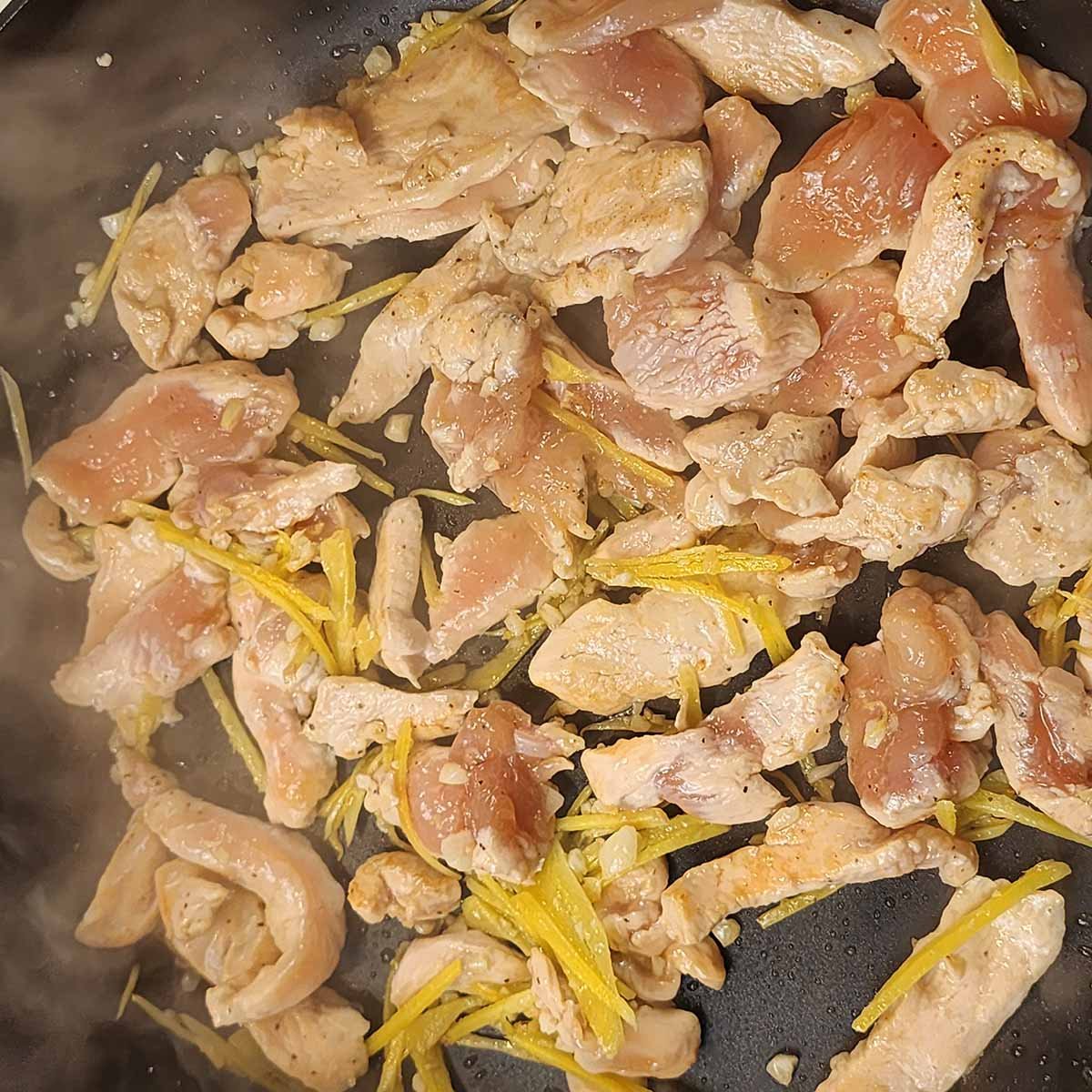 Chicken cooking in a wok