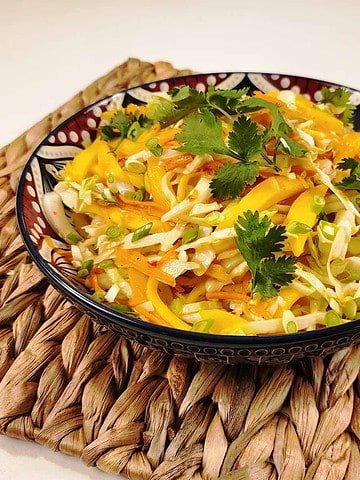 Thai coleslaw with shredded cabbage, carrots, and cilantro in creamy chili-lime dressing