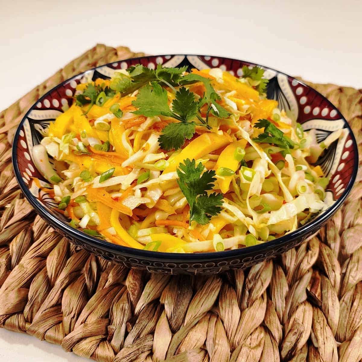 Thai coleslaw with shredded cabbage, carrots, and cilantro in creamy chili-lime dressing