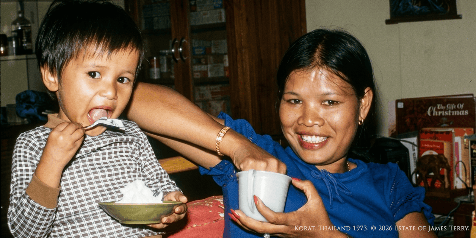 Susie Thompson as a young child being fed by her mother Pien, Korat Thailand 1973